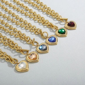 Close-up of heart-shaped crystal pendants with OT clasp on gold-plated chunky chains