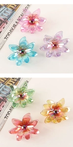 Detailed view of colorful iridescent flower hair claws in six different pastel shades