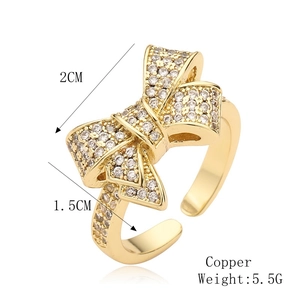 Detail of copper bow ring with white zircon stones and dimension labels