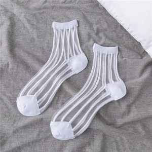 Detail of white semi-transparent crew socks with vertical stripes on soft fabric
