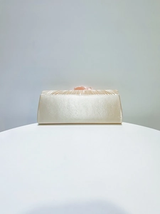 Elegant pleated satin evening clutch bag with pink flower decoration for banquets.