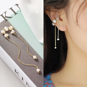 Baroque pearl tassel ear cuff with gold chains and irregular pearls in a split view