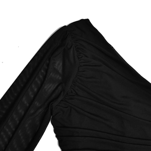Détail de l'épaule en mesh noir et fronces sur cette mini-robe asymétrique