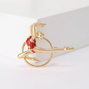 Golden rhythmic gymnastics girl brooch with red enamel detailing for suits and fashion