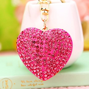 Close-up of pink heart slipper keychain featuring sparkly rhinestones and gold metal clasp