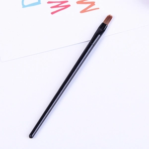 Detail of a thin black handle makeup brush with brown pointed tip for eyeliner and precision