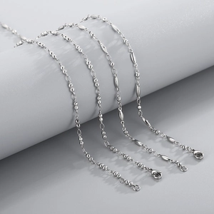 Detailed view of silver stainless steel beaded chains with polished metallic finish