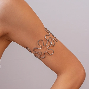 Close-up of a silver hollow wavy flower arm cuff bracelet on woman's upper arm