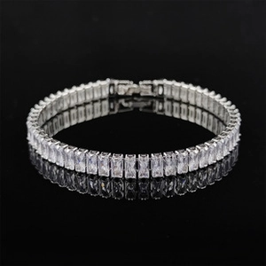Close-up of adjustable silver tennis bracelet featuring rectangular zircon stones