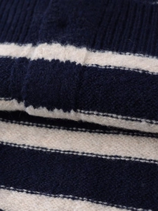Detailed close-up of thick navy blue and cream striped knit fabric with soft texture