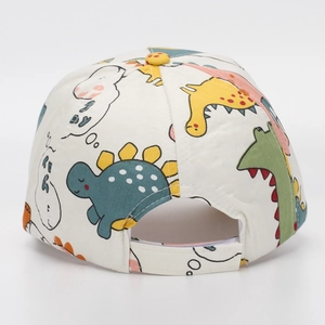Detail view of the back of children's white baseball cap with dinosaur pattern and velcro strap