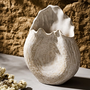 Artistic white ceramic vase with golden texture for elegant home floral arrangements