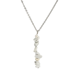 Detail view of silver chain necklace with natural white stone pebbles and tassel elements