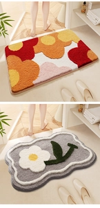 Close-up of floral absorbent bathroom mats with soft tufted texture and non-slip backing