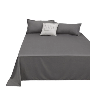 Three-piece dark grey washed cotton bedding set with flat sheet and matching pillowcases