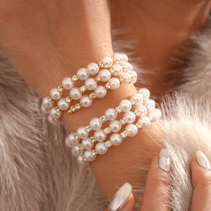 Macro shot of multi-layer faux pearl bracelet with sparkling rhinestone spacers