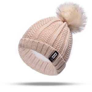 Women's warm cable-knit beanie hat with faux fur pom pom and folded brim in beige