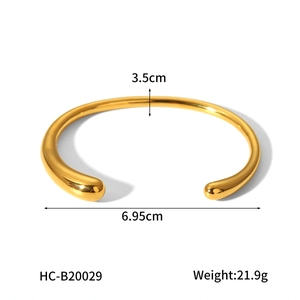 Detailed view of polished 18K gold-plated titanium steel bangle with size specifications