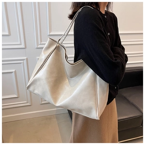 Detail of soft cream leather tote bag shoulder strap and premium pebbled texture