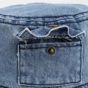 Blue washed denim bucket hat featuring a vintage side pocket and copper metal snap button