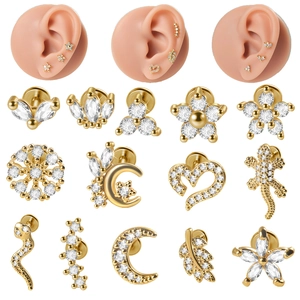 Macro view of gold-plated stainless steel earrings with moon, snake and flower designs