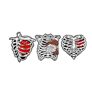 Three-piece gothic skull ribcage enamel pin set with heart and floral designs