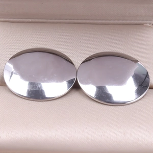 Close-up of polished 304 stainless steel geometric stud earrings on beige velvet