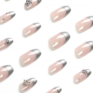Pink nude press-on nails with silver French tips and star rhinestones on white background