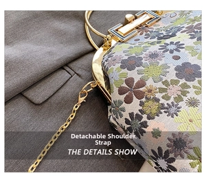 Detail of floral handbag showing detachable gold chain strap and circular metal handle