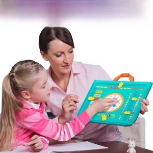 Macro view of blue felt busy board showing clock and interactive calendar for kids
