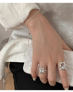 Detailed close-up of 925 sterling silver square gemstone ring and irregular geometric ring