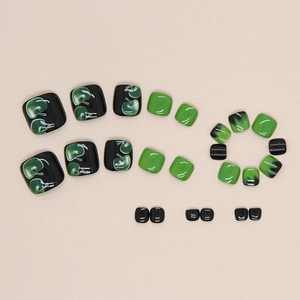 Faux ongles d'orteils avec motifs de pommes vertes et design contrasté noir et vert