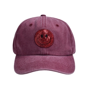 Burgundy washed cotton baseball cap featuring a decorative red sequin smiley face patch