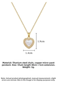 Macro view of gold titanium steel heart necklace with cubic zirconia and pearl shell inlay