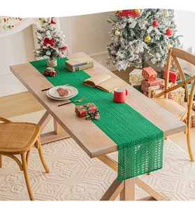 Detailed knit pattern on a green Christmas table runner set in a festive dining scene