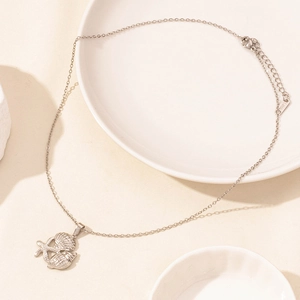 Detailed close-up of starfish, scallop and shell pendants on a stainless steel chain