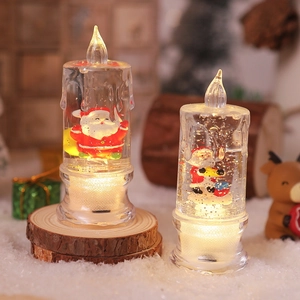 Detail of light-up Christmas water candles with Santa figures and warm glowing LED lights