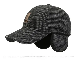 Side view of winter wool baseball cap with ear flaps and white brand lettering