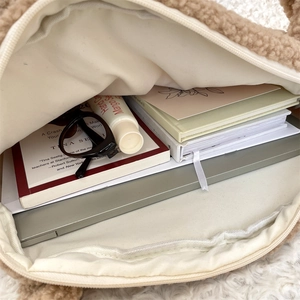 Interior view of large capacity plush tote bag showing laptop and daily essentials