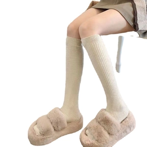 Winter rib-knit over-knee long socks paired with plush platform slippers in cream white