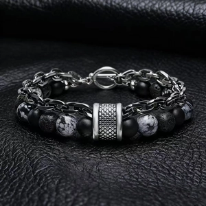 Detail of men's layered bracelet with matte map stone, lava rock, and steel chain