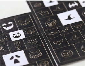 Detail view of Halloween nail stencils with pumpkin, ghost and bat patterns for airbrushing