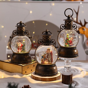 Vintage bronze Christmas lantern with snow globe featuring Santa Claus and warm festive lights