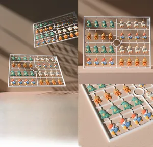 Macro detail of resin cartoon nail art charms with dinosaur and bee designs