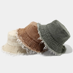 Washed denim bucket hats with frayed edges in beige, brown, and dark grey for sun protection