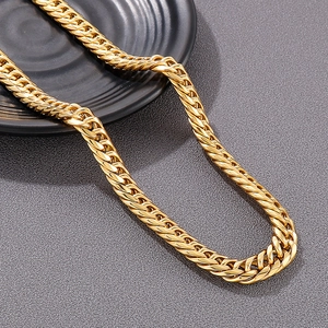Detailed close-up of a polished gold cuban link chain on a sleek black tray display