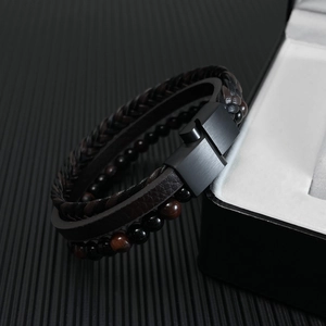 Detail of multi-layer leather bracelet with tiger eye beads and black magnetic clasp