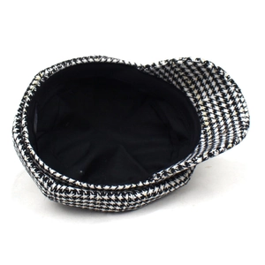Classic black and white houndstooth newsboy cap with warm lining and vintage style