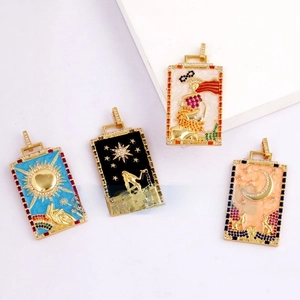 Detailed close-up of tarot card pendants with inlaid cubic zirconia and enamel icons