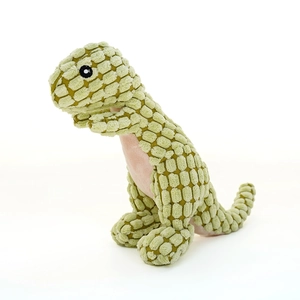 Macro detail of the green plush dinosaur toy showing durable corn fleece texture and seams